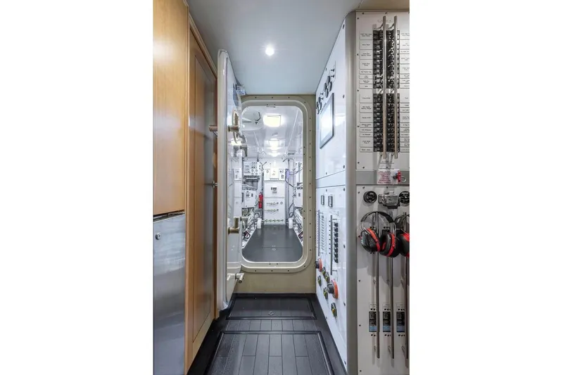 Slide: The Image of Engine room of 2014 Pacific Mariner 85 Motor Yacht, featuring control panels and equipment. - 52