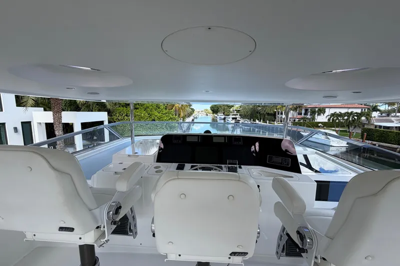 Slide: The Image of Flybridge view of 2014 Pacific Mariner 85 Motor Yacht, featuring helm and seating area. - 6