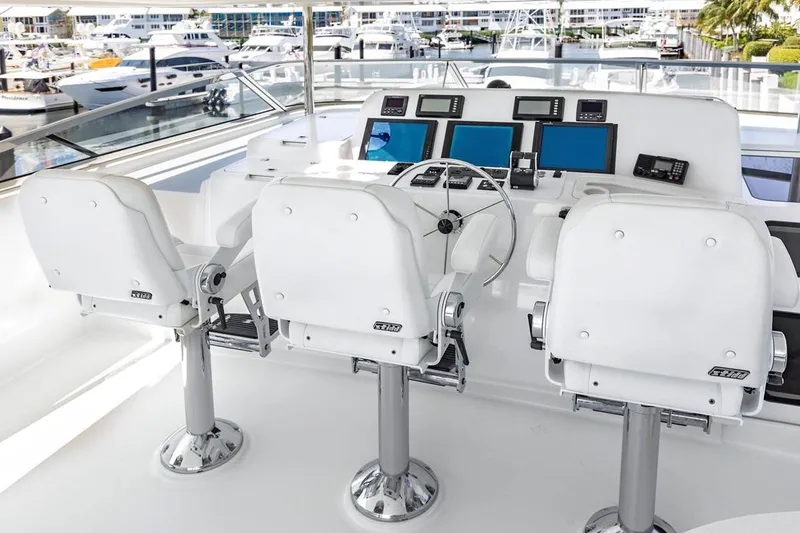 Slide: The Image of Helm station of 2014 Pacific Mariner 85 Motor Yacht with three white captain chairs. - 7