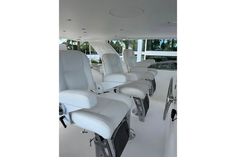 Slide: The Image of Luxurious white seating on 2014 Pacific Mariner 85 Motor Yacht's helm station. - 9