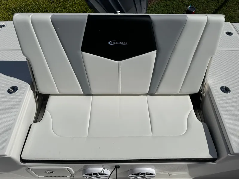 Slide: The Image of 2024 Robalo 226 Cayman boat seat with sleek white and black design. - 10