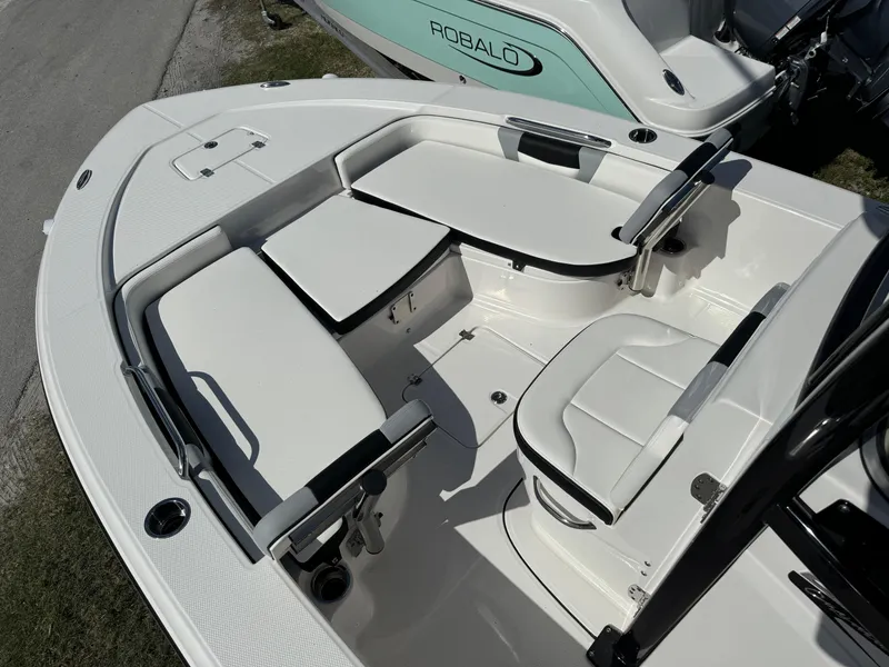 Slide: The Image of 2024 Robalo 226 Cayman boat interior with seating and storage compartments. - 13