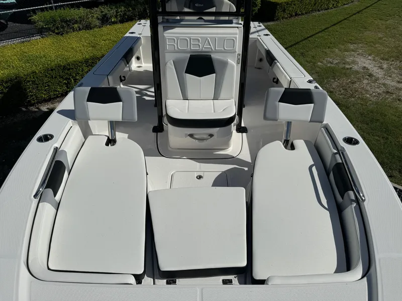 Slide: The Image of 2024 Robalo 226 Cayman boat interior with white seating and sleek design. - 14