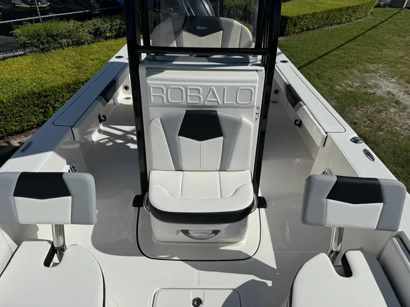 Slide: The Image of 2024 Robalo 226 Cayman boat interior with white seating and sleek design. - 15