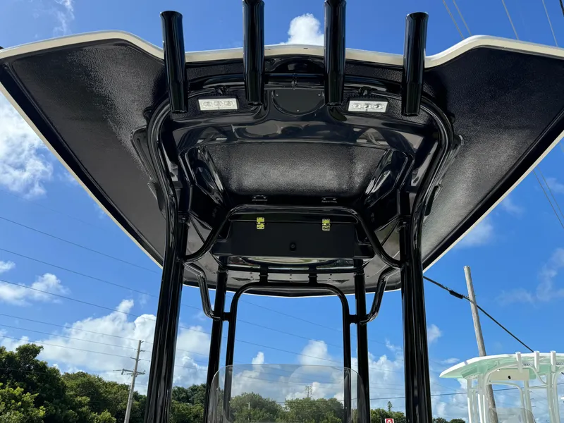 Slide: The Image of 2024 Robalo 226 Cayman T-top view under blue sky. - 7