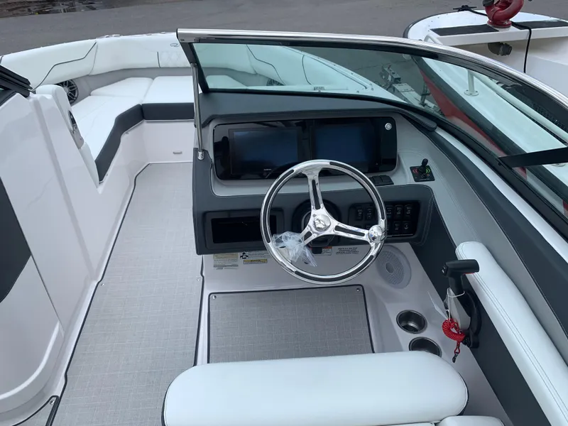 Slide: The Image of 2024 Regal LX4 boat cockpit with modern steering wheel and dual displays. - 12