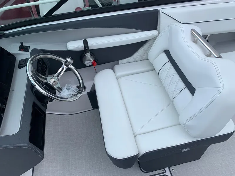 Slide: The Image of 2024 Regal LX4 boat interior with white captain's seat and steering wheel. - 14
