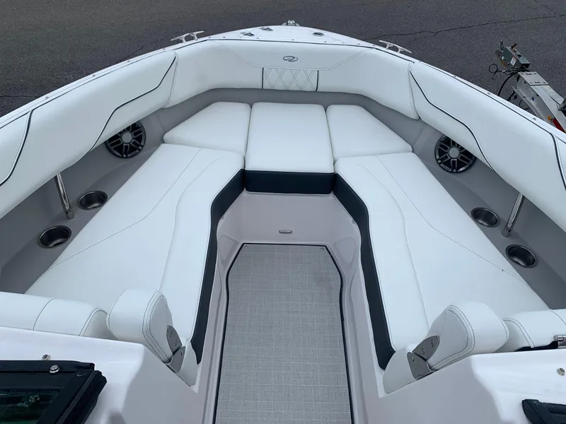 Slide: The Image of 2024 Regal LX4 boat interior with white cushioned seating and built-in speakers. - 18