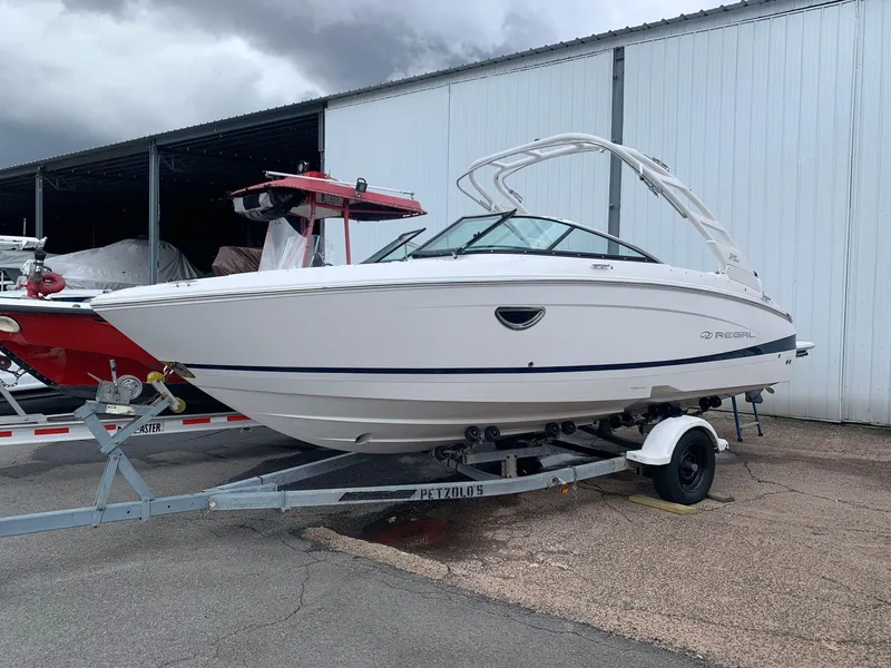 Slide: The Image of 2024 Regal LX4 boat on trailer outside storage facility. - 3