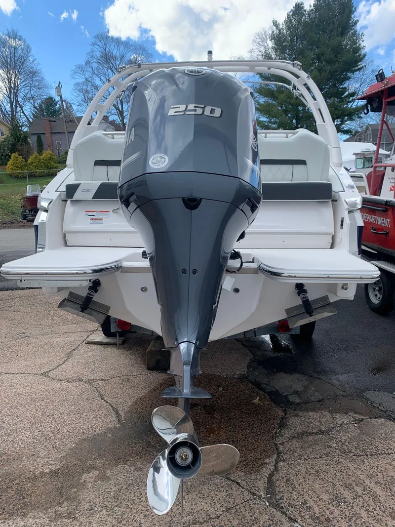 Slide: The Image of 2024 Regal LX4 boat with a 250 HP outboard motor, rear view. - 5