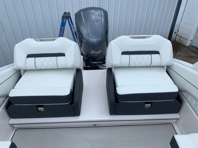 Slide: The Image of 2024 Regal LX4 boat with dual white cushioned seats and powerful outboard motor. - 9