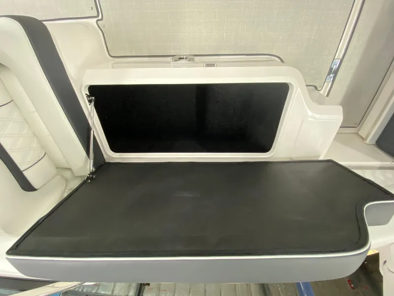 Slide: The Image of Open storage compartment in 2025 Regal LX6 boat interior. - 11