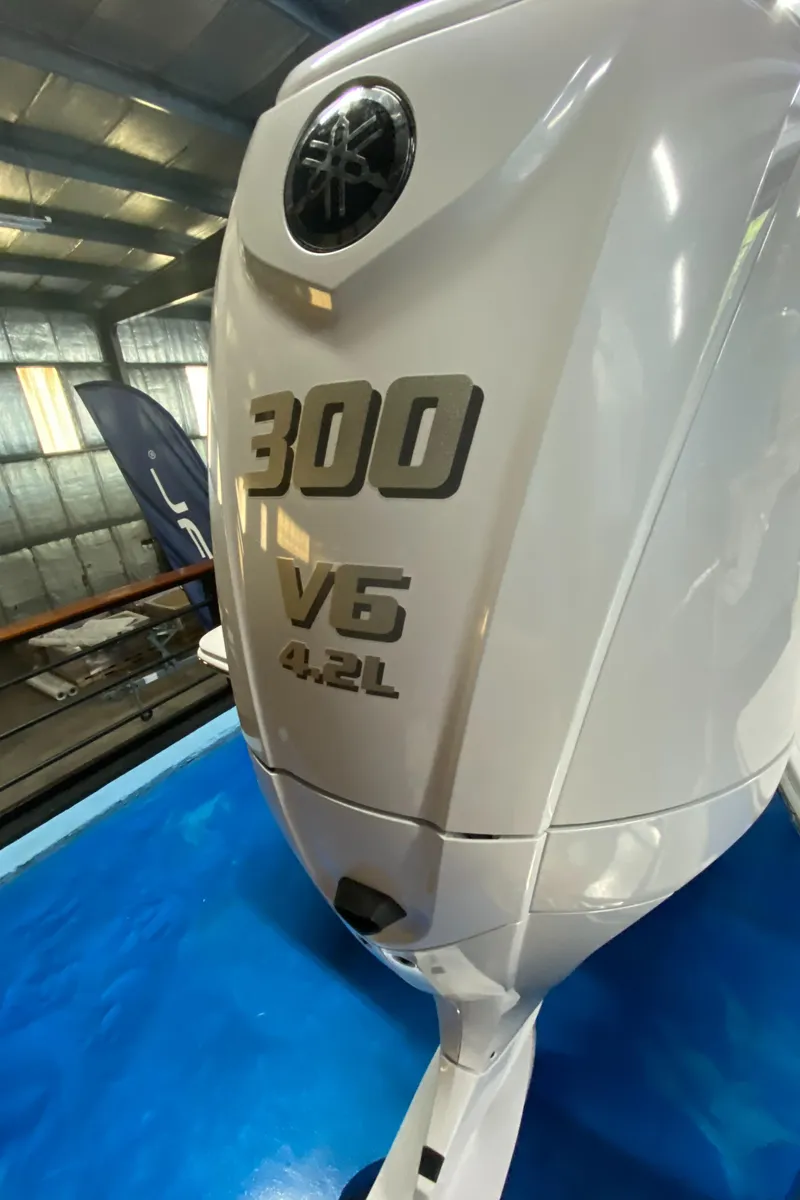 Slide: The Image of 2025 Regal LX6 boat with 300 V6 4.2L engine in a showroom. - 19