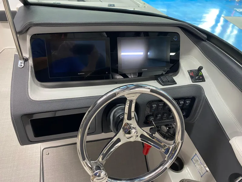Slide: The Image of 2025 Regal LX6 boat dashboard with dual screens and sleek steering wheel. - 5