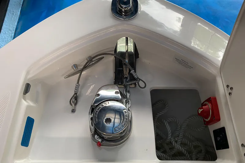 Slide: The Image of 2025 Regal LX6 boat anchor compartment with winch and rope storage. - 8