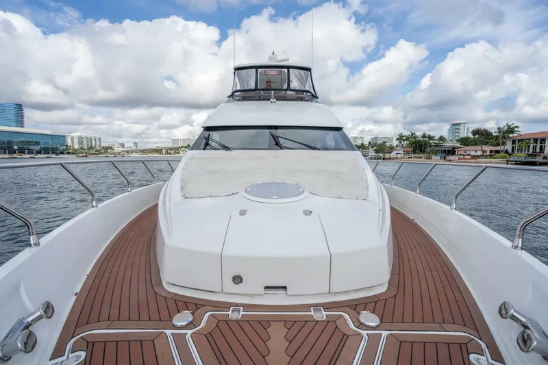 Slide: The Image of 2006 Marquis 59 yacht with sleek deck design, cruising on a sunny day. - 15