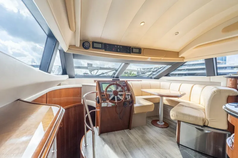 Slide: The Image of Luxurious interior of a 2006 Marquis 59 yacht with plush seating and modern helm. - 17