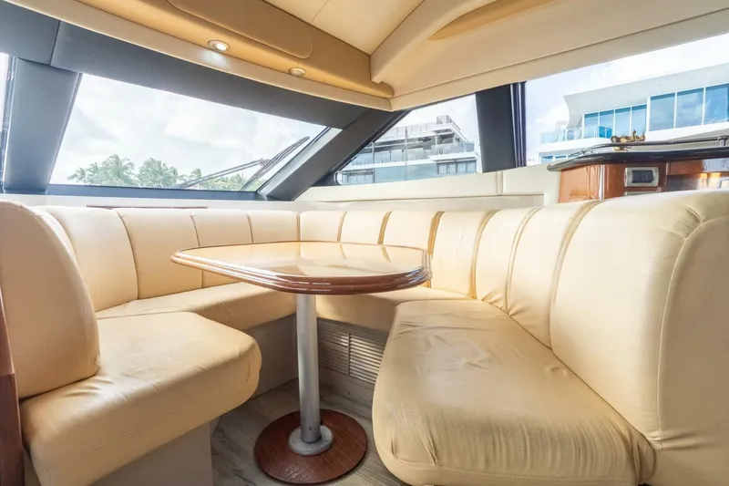 Slide: The Image of Interior of 2006 Marquis 59 yacht with beige seating and wooden table. - 20