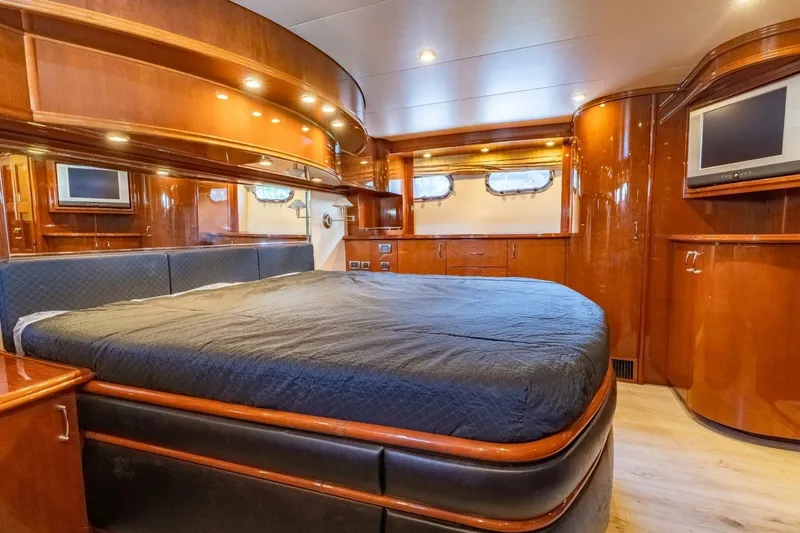 Slide: The Image of Luxurious 2006 Marquis 59 yacht bedroom with elegant wood finishes and modern amenities. - 27