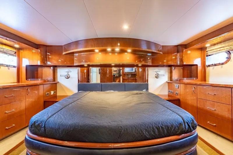 Slide: The Image of Luxurious 2006 Marquis 59 yacht bedroom with elegant wood finishes and ambient lighting. - 28