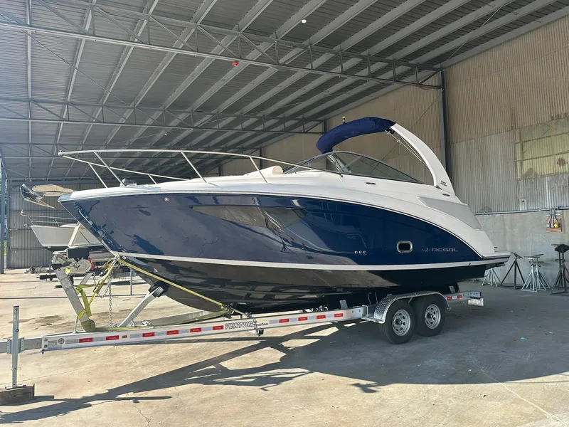 The Image of 2025 Regal 26XO boat on trailer in covered storage facility. - 0