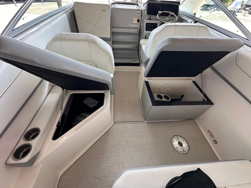Slide: The Image of 2025 Regal 26XO boat interior with open storage compartments and modern seating. - 15