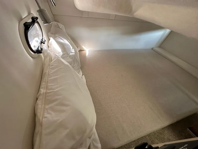 Slide: The Image of Cozy cabin interior of 2025 Regal 26XO boat with bedding and porthole. - 28