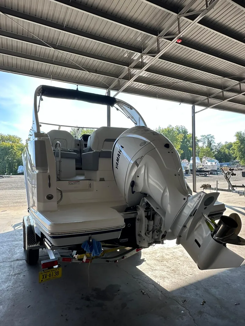 Slide: The Image of 2025 Regal 26XO boat with outboard motor in covered storage. - 3