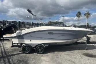 The Image of 2017 Sea Ray SPX 210 Outboard boat on trailer, parked outdoors under cloudy sky. - 0