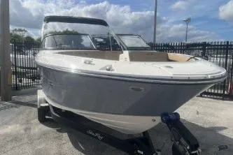 Slide: The Image of 2017 Sea Ray SPX 210 Outboard boat on trailer, parked outdoors. - 2