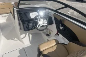 Slide: The Image of 2017 Sea Ray SPX 210 Outboard boat interior with steering wheel and seating. - 8