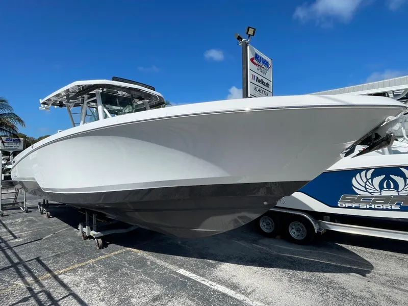 The Image of 2023 Wellcraft 352 Fisherman boat displayed outdoors on a sunny day. - 1
