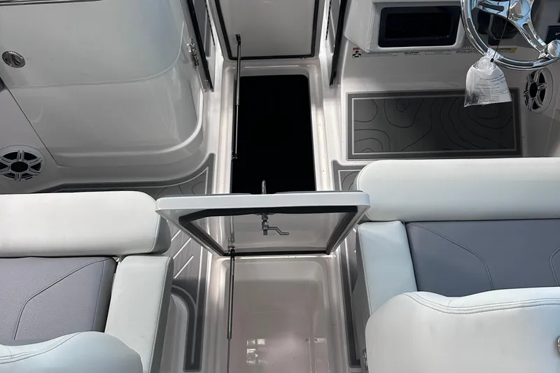 Slide: The Image of 2026 Regal LX9 boat interior with sleek seating and modern steering wheel design. - 17