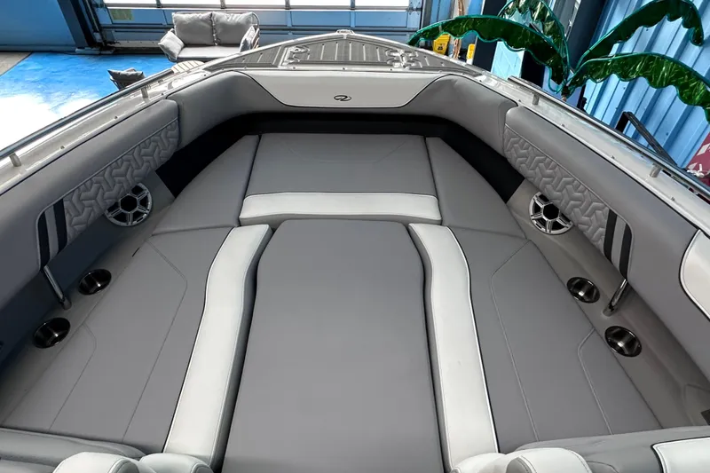 Slide: The Image of 2026 Regal LX9 boat interior with gray and white seating, cup holders, and speakers. - 20