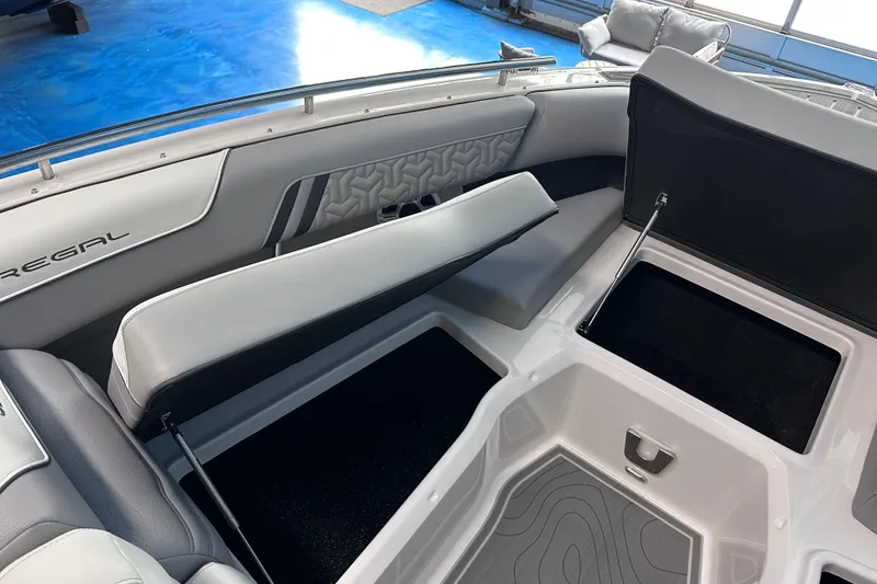 Slide: The Image of 2026 Regal LX9 boat interior with open storage compartments and sleek seating design. - 21