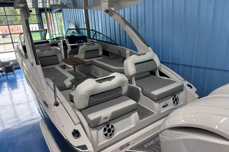 Slide: The Image of 2026 Regal LX9 boat interior with luxurious seating and modern design in a showroom. - 4