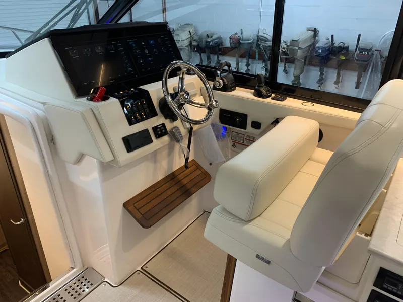 Slide: The Image of 2023 Regal 36XO boat helm with modern controls and comfortable seating. - 12