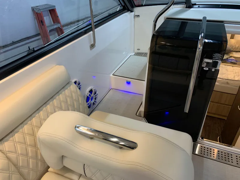 Slide: The Image of 2023 Regal 36XO boat interior with white leather seating and modern amenities. - 15