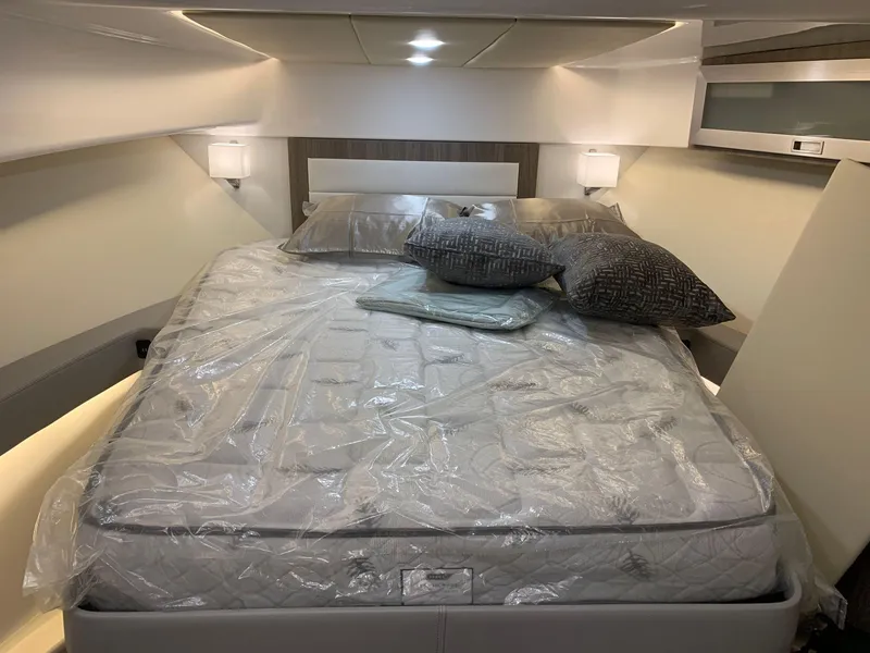 Slide: The Image of Luxurious bedroom in 2023 Regal 36XO yacht with modern lighting and plush bedding. - 21