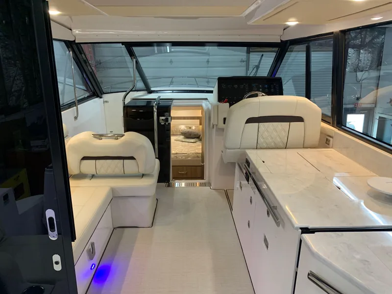 Slide: The Image of 2023 Regal 36XO yacht interior with modern seating and kitchen area. - 5