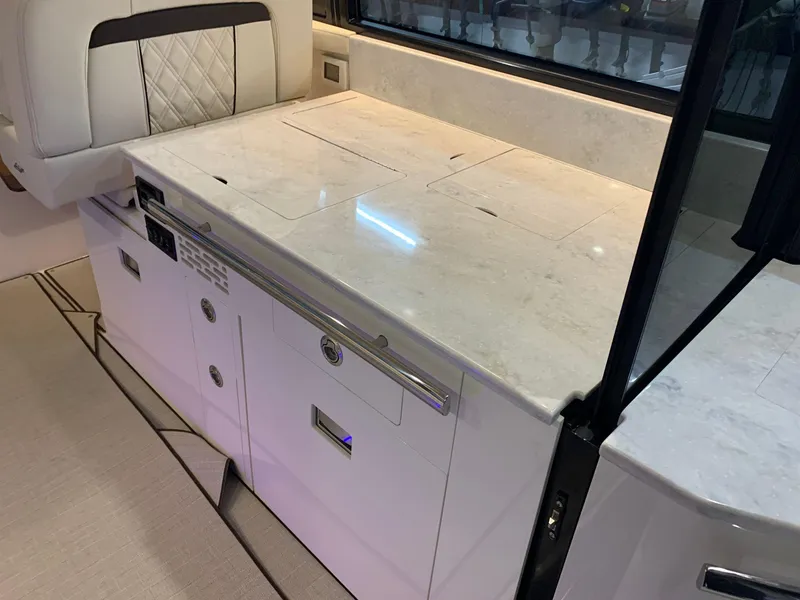 Slide: The Image of 2023 Regal 36XO yacht interior with modern kitchen countertop and storage cabinets. - 6