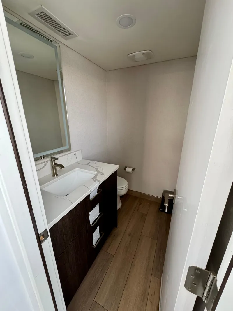 Slide: The Image of Modern bathroom in Adonia Pace Trip #7, 2021 model, featuring sleek vanity and wood flooring. - 29