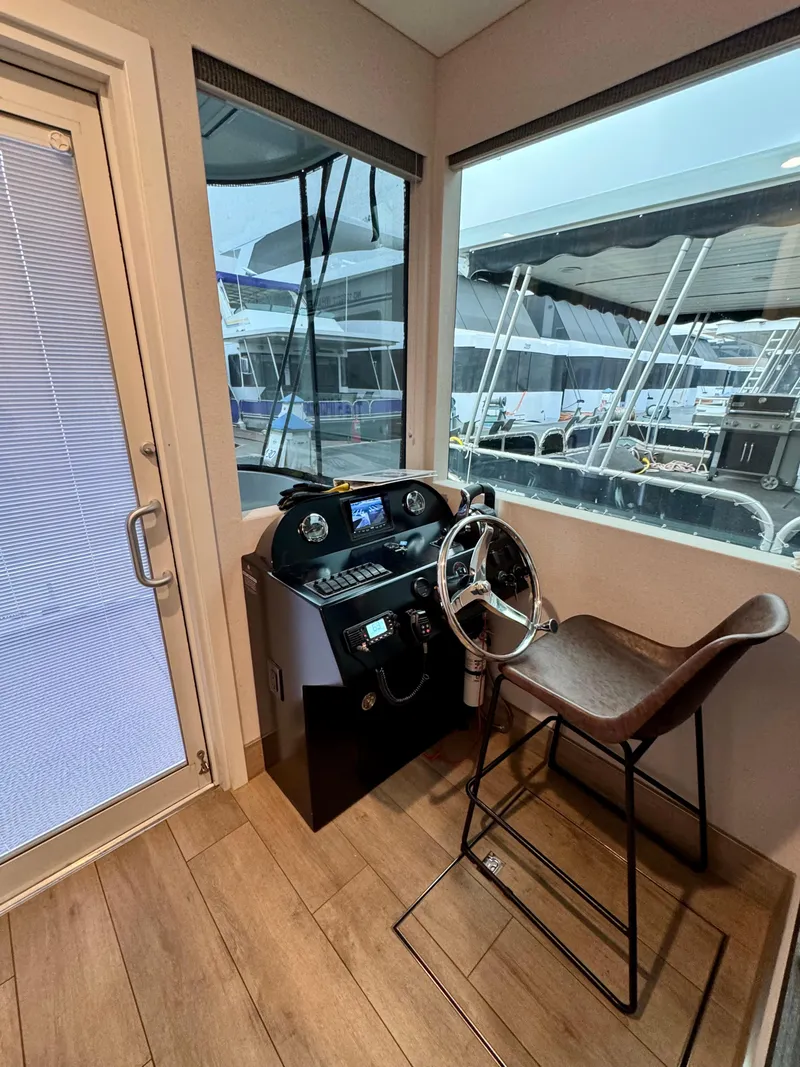 Slide: The Image of Modern boat helm with steering wheel, Adonia Pace Trip #7, 2021 model, docked at marina. - 3