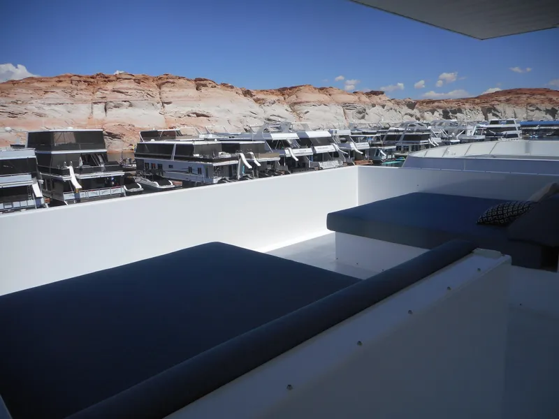 Slide: The Image of Adonia Pace Share #8 2021 houseboats docked near rocky cliffs under clear blue sky. - 37
