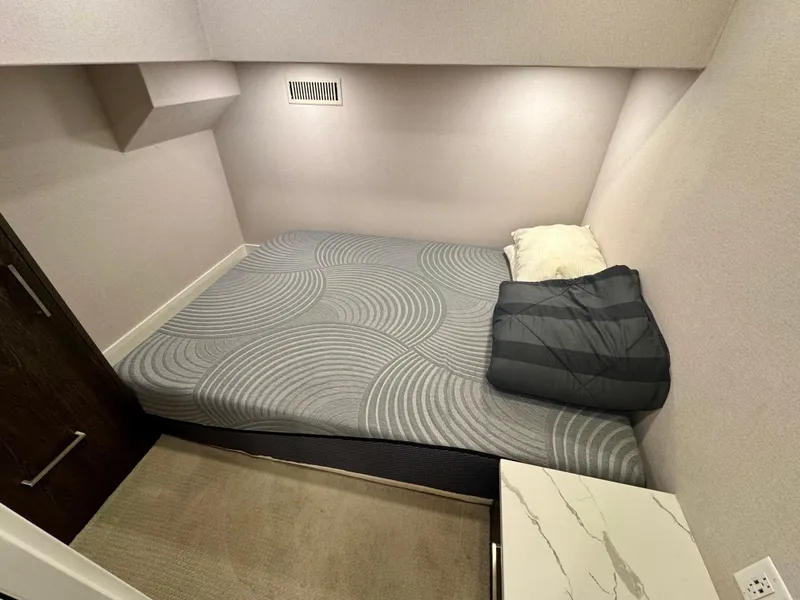 Slide: The Image of Compact sleeping area in 2021 Adonia Pace Trip #7 RV with modern bedding. - 6