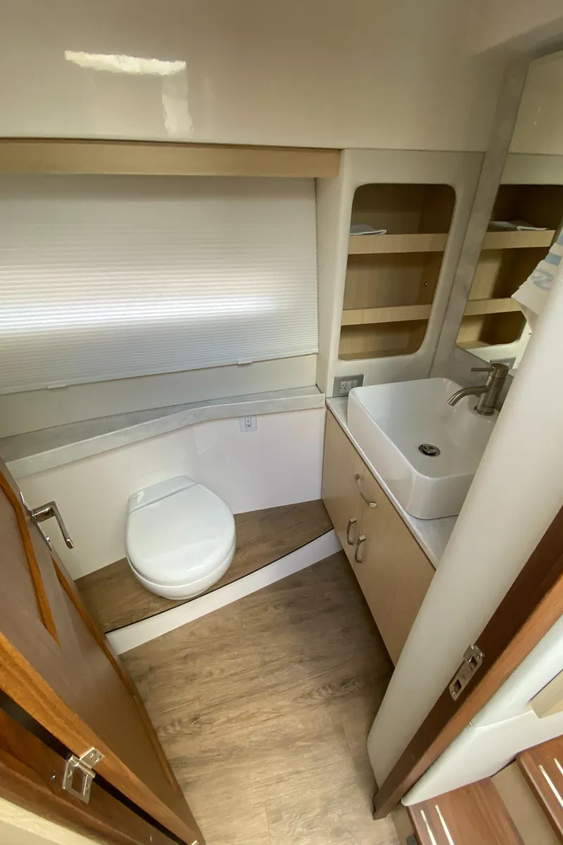 Slide: The Image of 2024 Regal 38XO yacht bathroom with modern fixtures and wooden accents. - 16