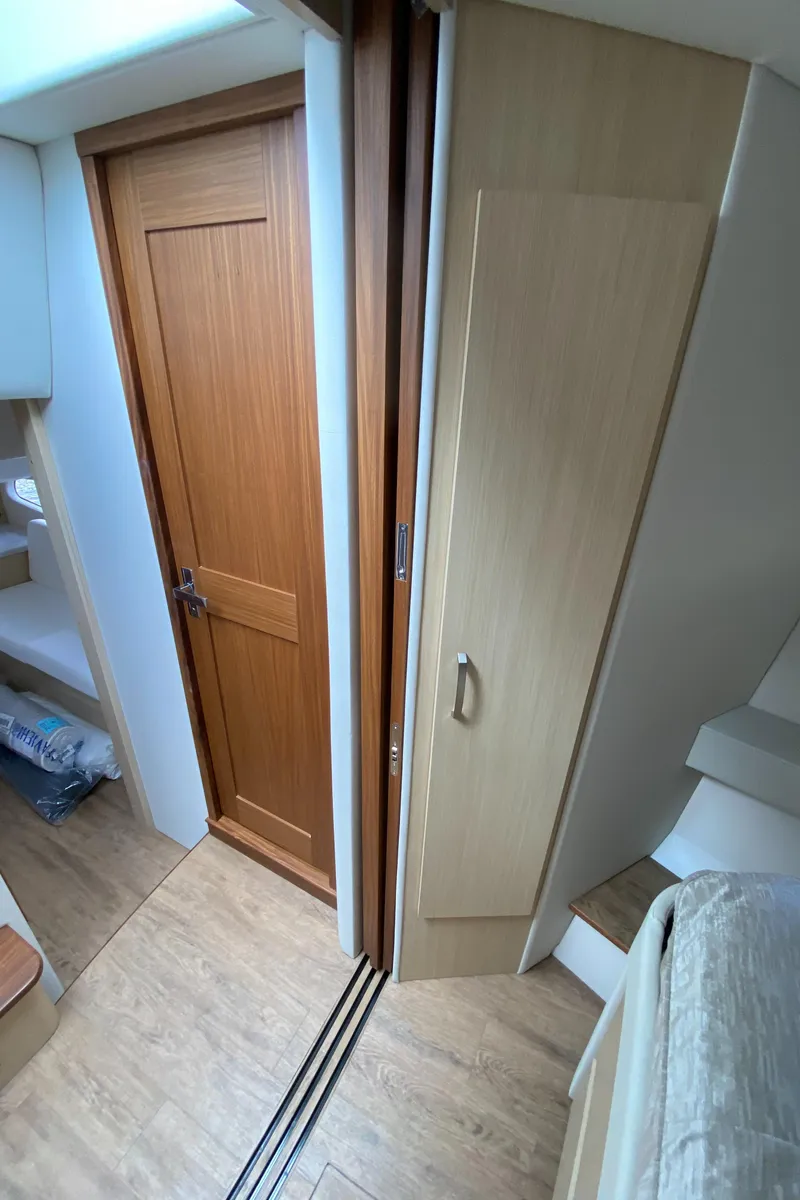 Slide: The Image of 2024 Regal 38XO interior cabin with wooden door and storage cabinets. - 18