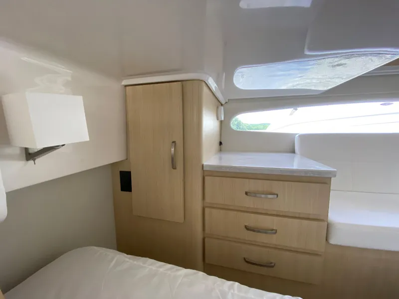 Slide: The Image of Interior cabin of 2024 Regal 38XO yacht with wooden cabinetry and natural light. - 21
