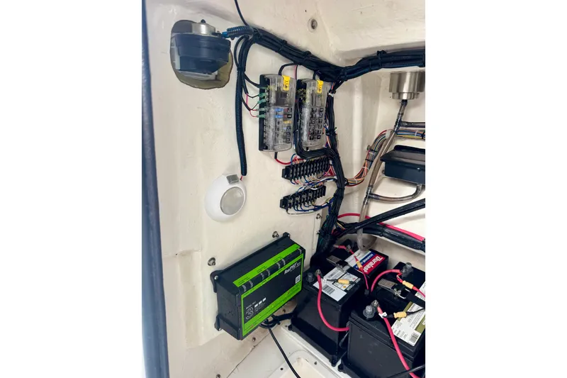 Slide: The Image of Electrical system of a 2023 BlackJack 256 Bay boat, featuring wiring and battery setup. - 12