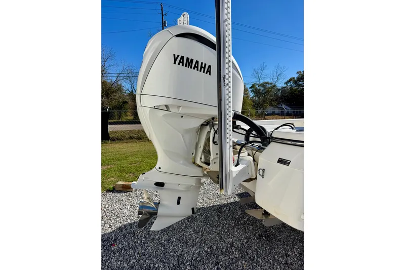 Slide: The Image of 2023 BlackJack 256 Bay boat with Yamaha outboard motor on gravel surface. - 4
